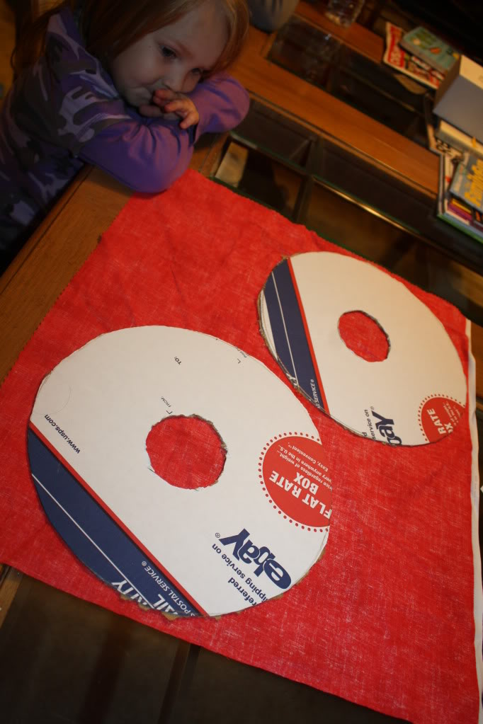https://www.amylovesit.com/wp-content/uploads/2009/11/061.jpg After you cut out the middle holes, trace out your wreath onto the fabric of your choice