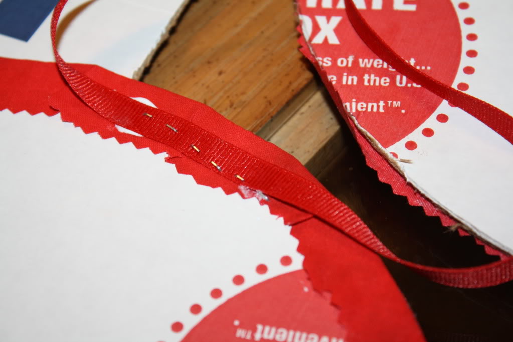 https://www.amylovesit.com/wp-content/uploads/2009/11/067.jpg Attach the ribbon to the back of the wreath with staples (will be covered later) and glue